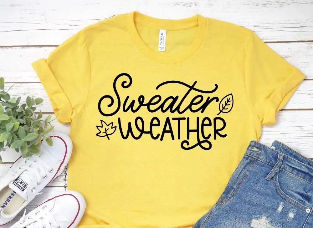 yellow shirt that says Sweater Weather in script with a little leaf