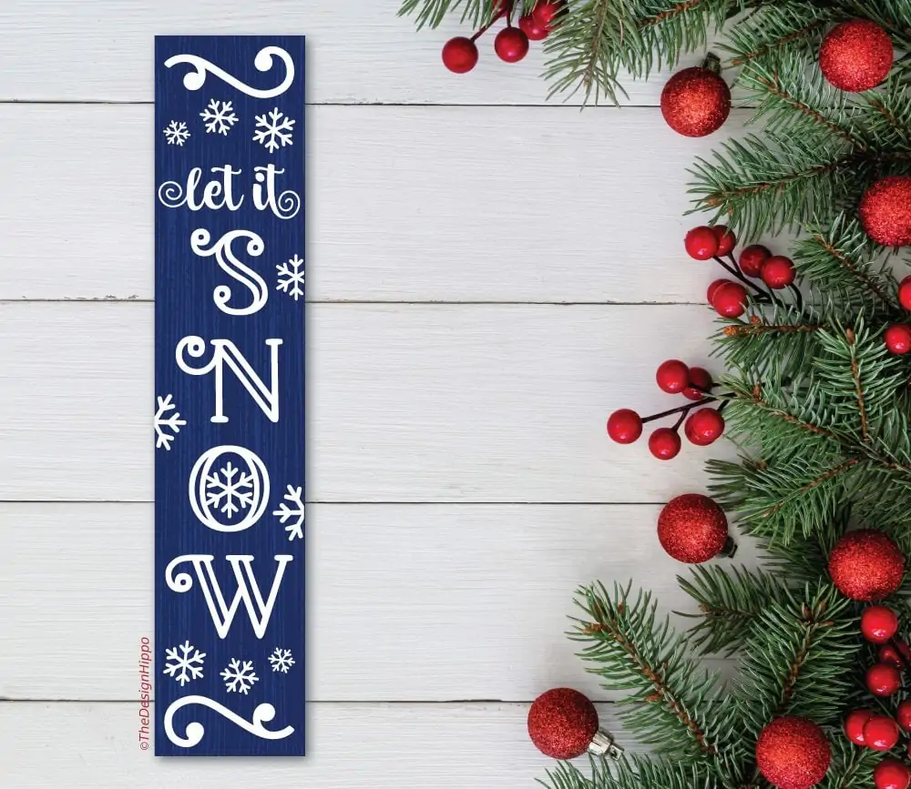 let it snow svg design on a wood plank made using Cricut