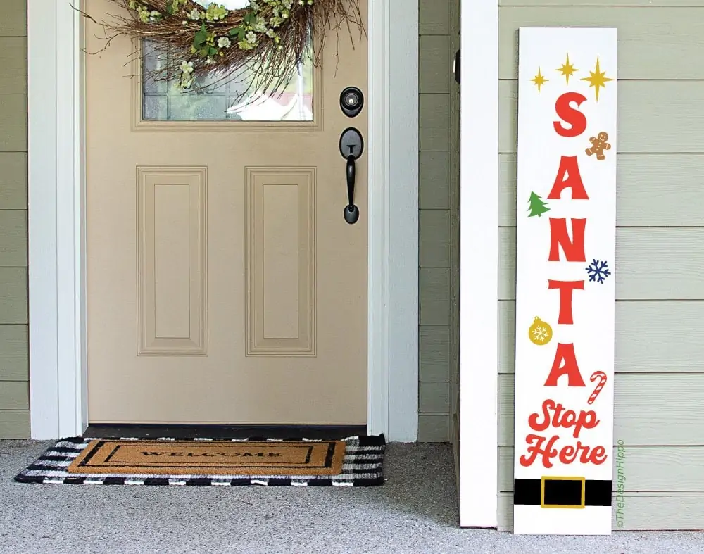 colorful Christmas porch sign design on a white vertical wood sign made using Cricut Maker