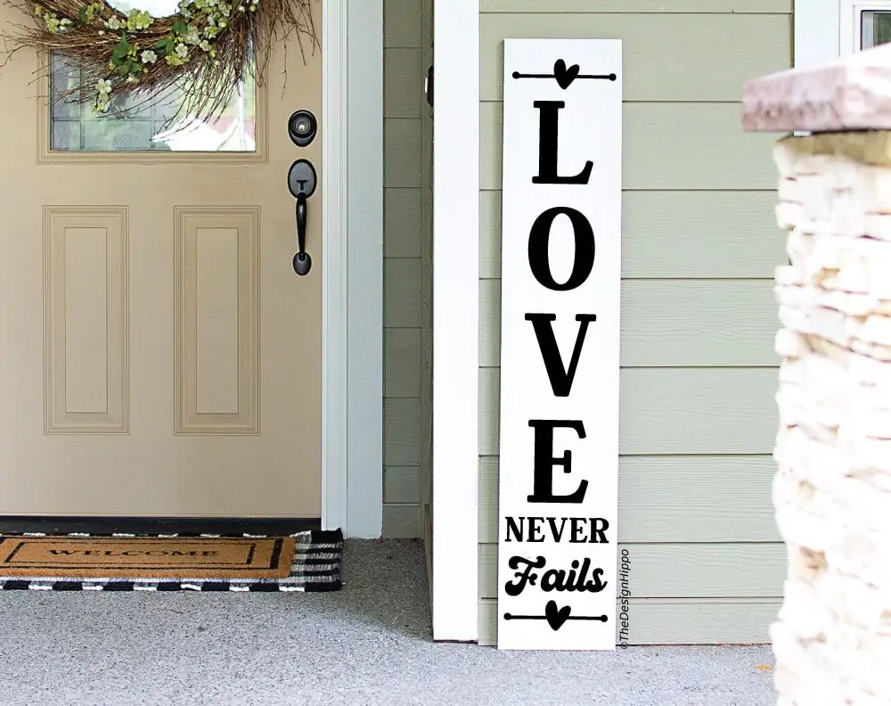 love never fails design on a white vertical porch sign made with Cricut
