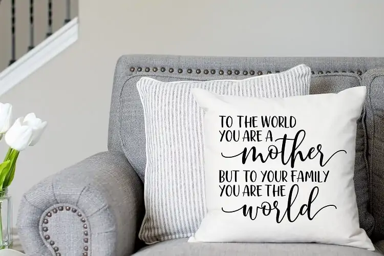 heartfelt mom quote cut with cricut vinyl displayed on a farmhouse pillow