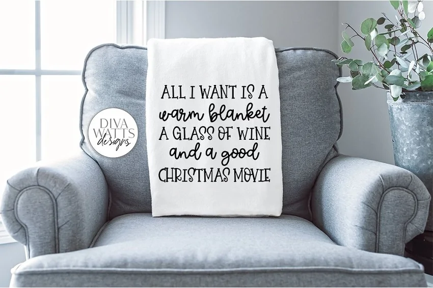 christmas blanket with a funny quote resting on a farmhouse chair
