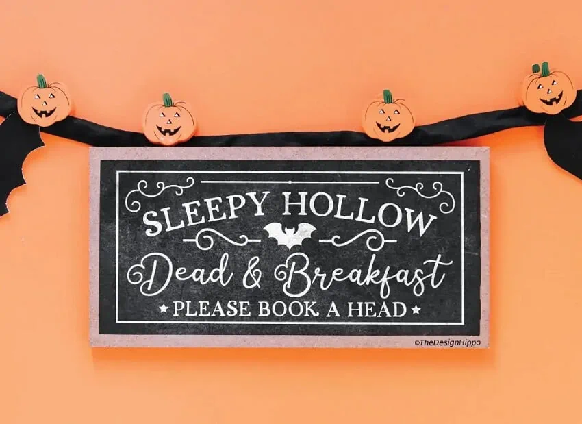 funny halloween svg cut file displayed on a wood sign