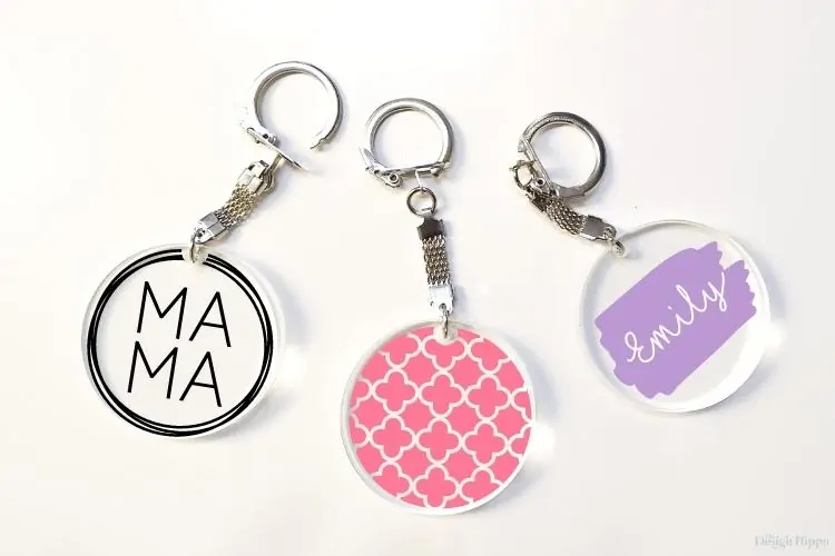 set of three Cricut keychain ideas displayed on round acrylic keychains