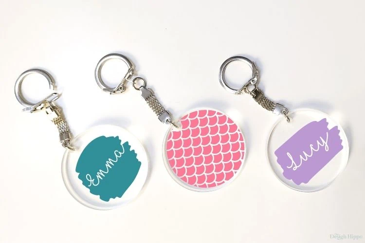 display of free round keychain svg designs on three round acrylic keychains made using Cricut Maker