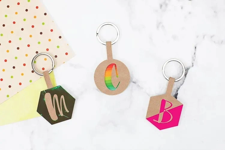 display of three personalized leather keychains made with Cricut