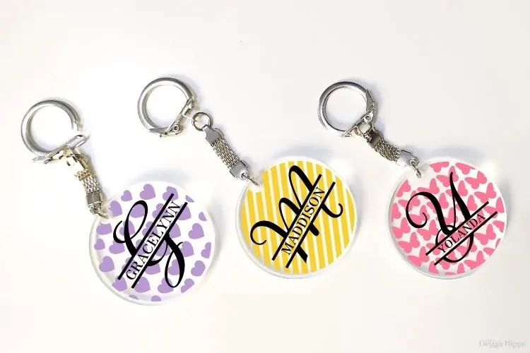 display of three personalized round acrylic keychain ideas with patterns made using Cricut machine