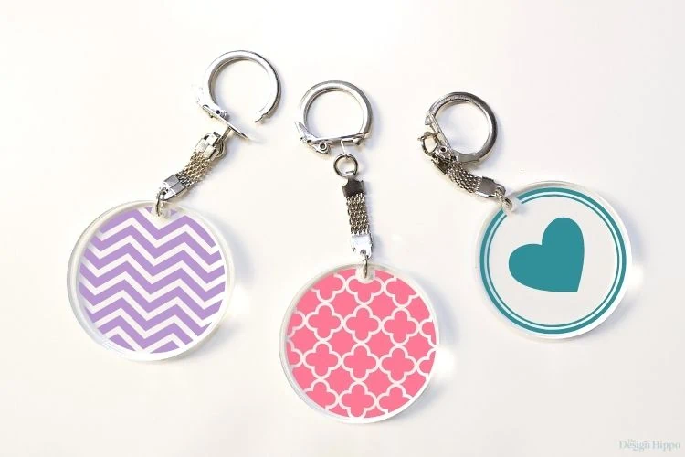 set of three round acrylic keychains with custom patterns made with Cricut