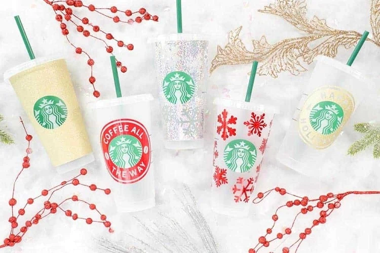 display of several customized 24 oz Starbucks cold cups on a colorful background