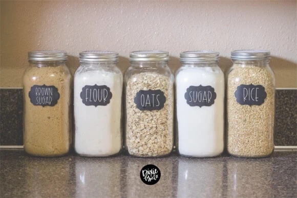 display of five glass storage jars with pantry labels made using Shiplap font