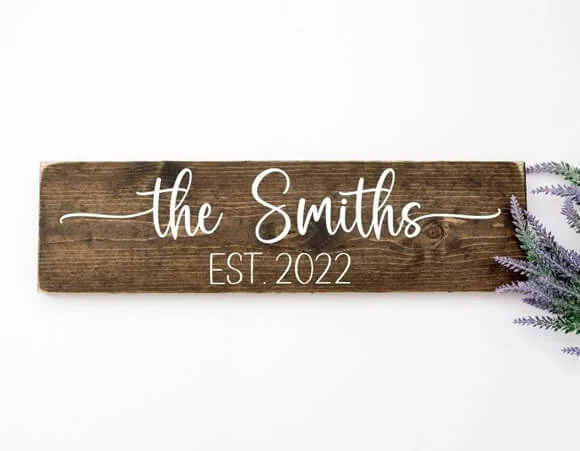 Custom wooden sign displaying 'The Smiths EST 2022' in the 'Country Kitchen' font, blending rustic charm with modern elegance.