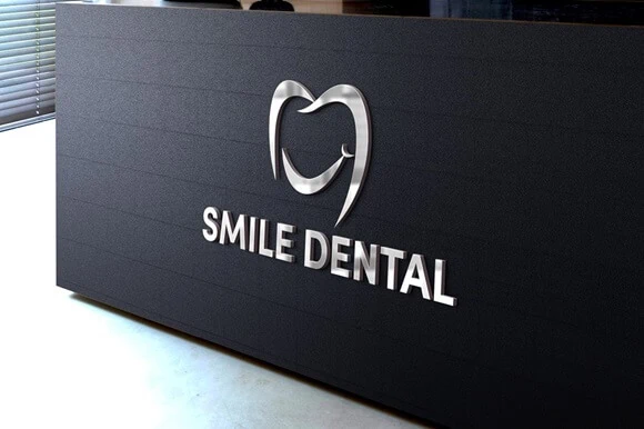 
Dental office exterior sign with 'Smile Dental' in a clean, contemporary font and a logo forming a heart-shaped tooth.
