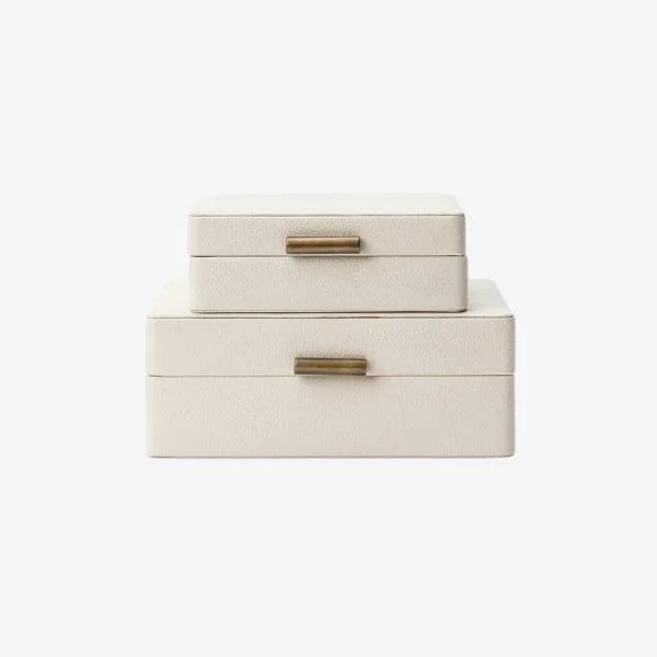Set of two cream leather decorative storage boxes with brass hardware