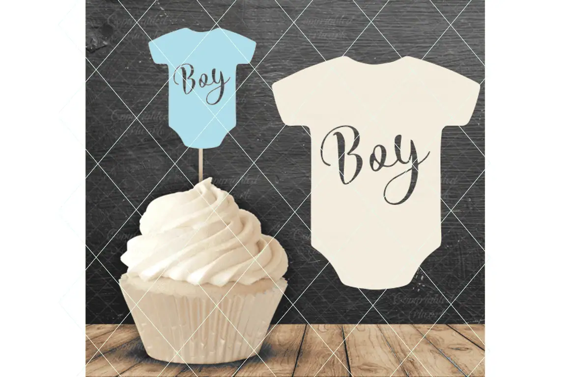 blue onesie shaped cupcake topper that says Boy on a cupcake, next to a cream onesie that says Boy