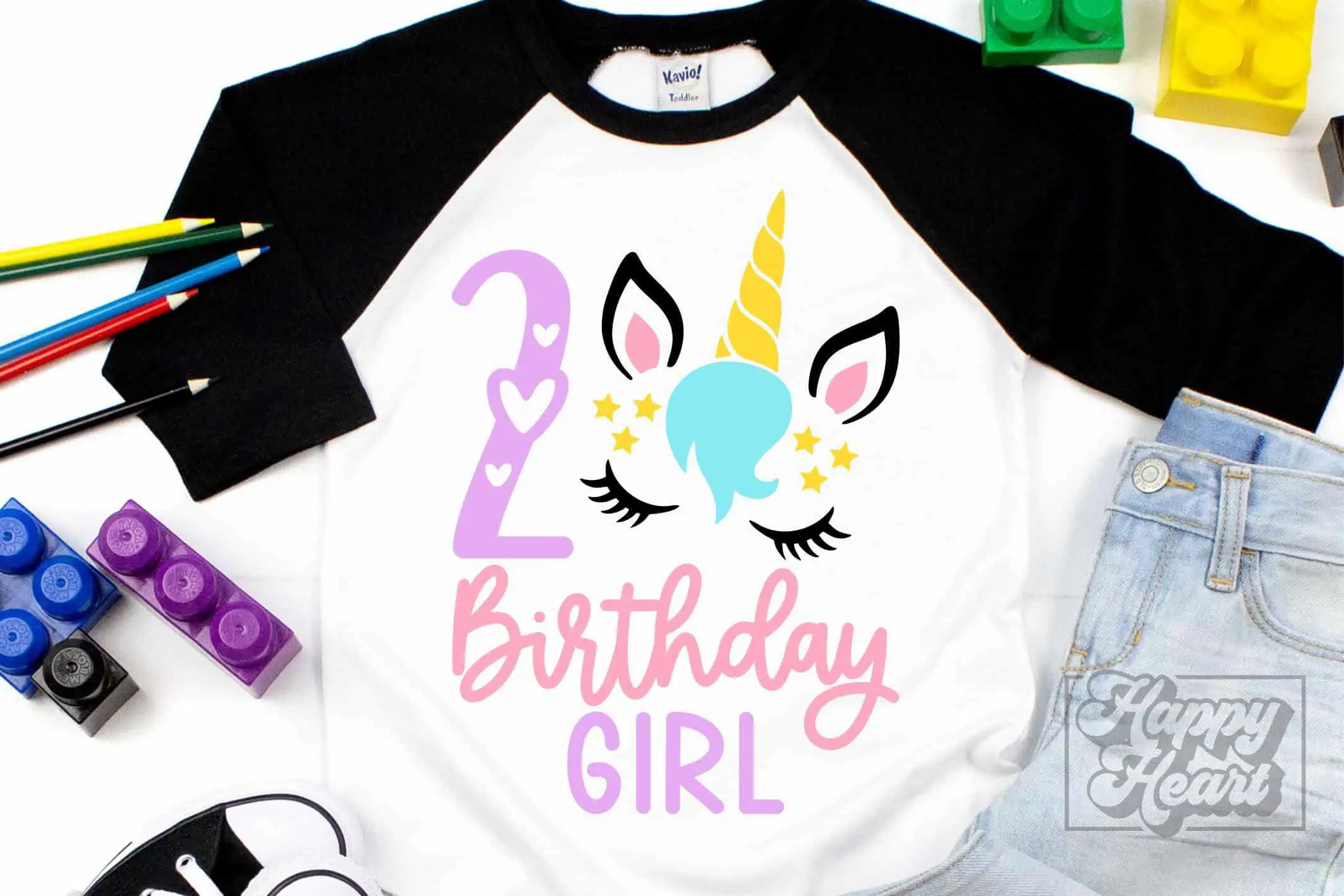 raglan shirt with a unicorn face, a number 2 and birthday girl in pink