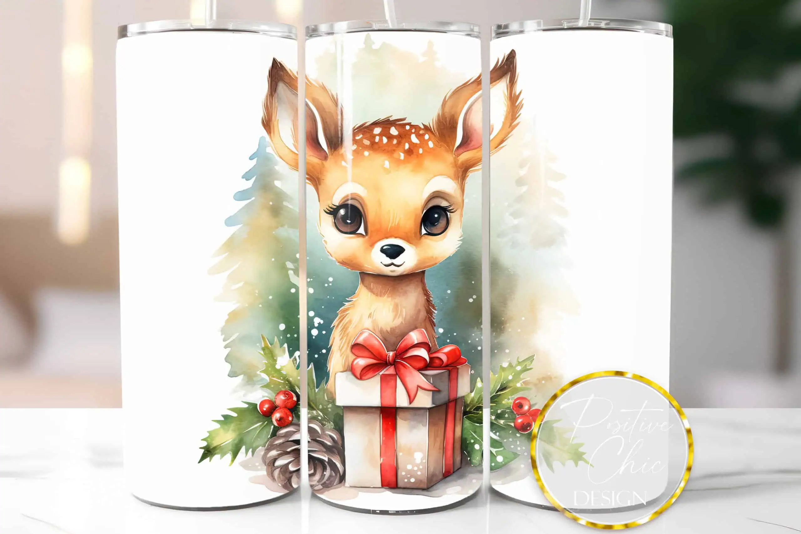 white skinny tumbler with a watercolor baby deer holding a red gift box in front of pine trees