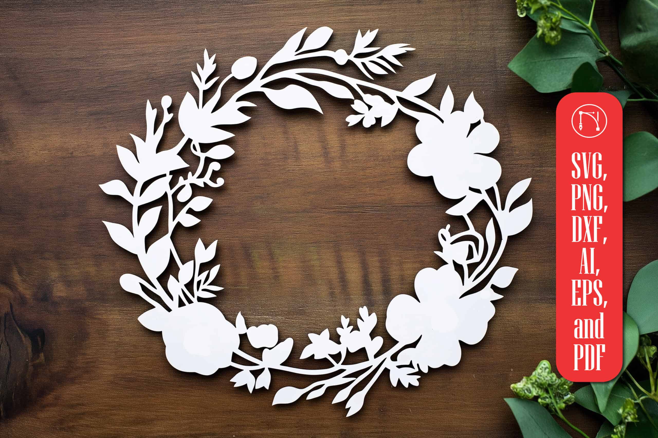 white paper cut wreath of flowers and leaves on a dark wood background