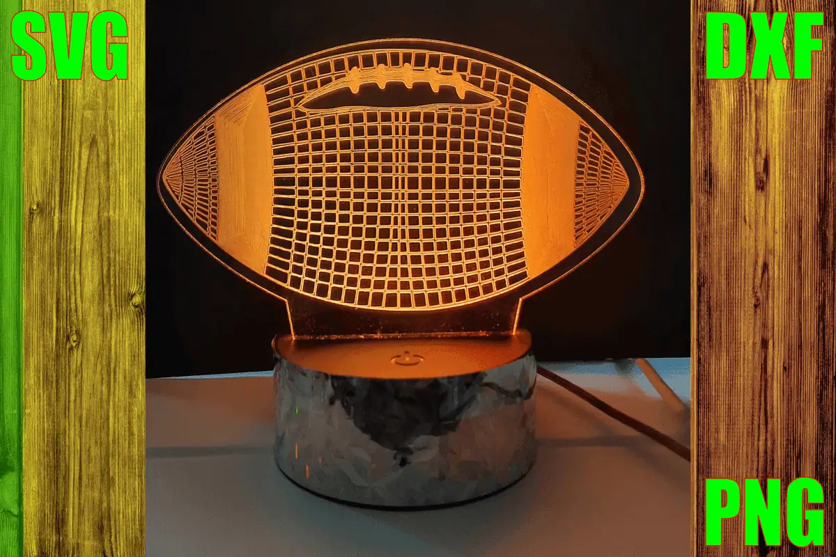 football shaped engraved acrylic lamp with a 3D grid pattern glowing orange on a wood base