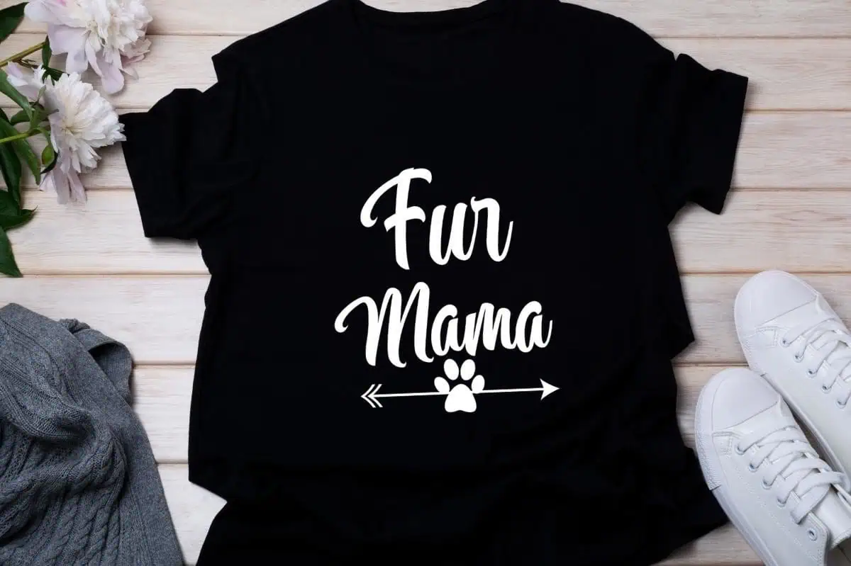 black shirt that says Fur Mama in white script with a paw print arrow
