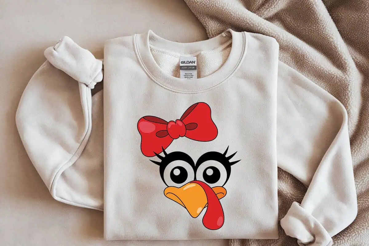 cream sweatshirt with a cute turkey face wearing a red bow