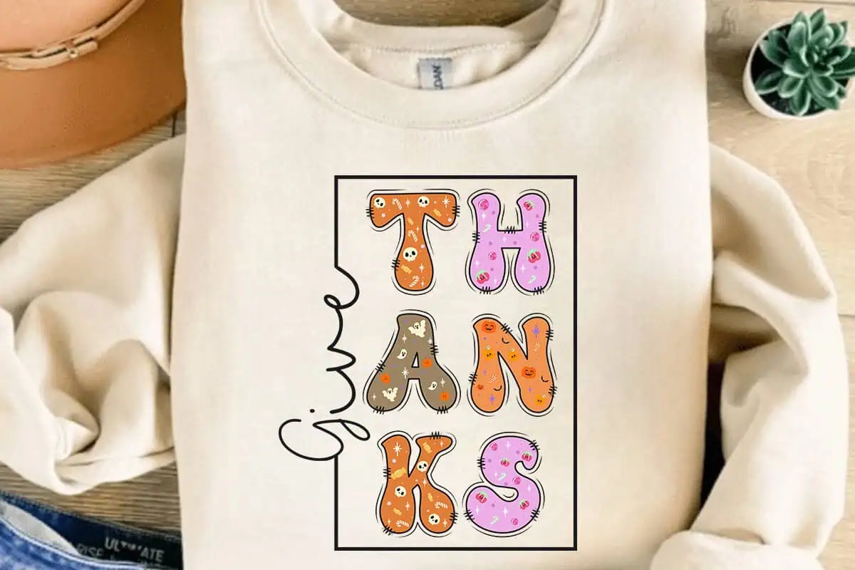 cream sweatshirt with stacked THANKS letters and give in script