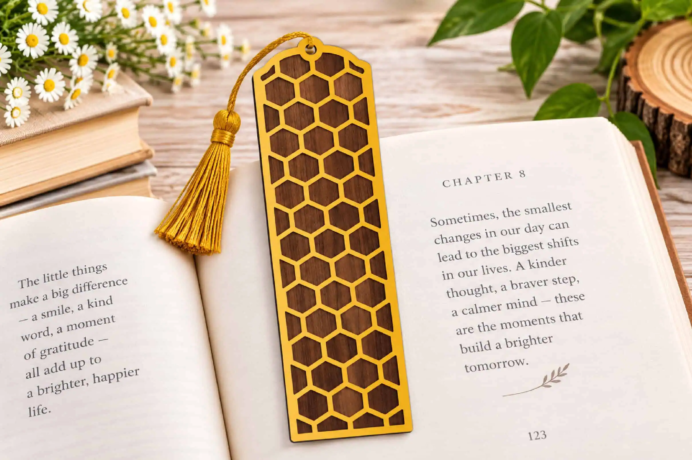 gold honeycomb bookmark over a brown backing with a yellow tassel on an open book