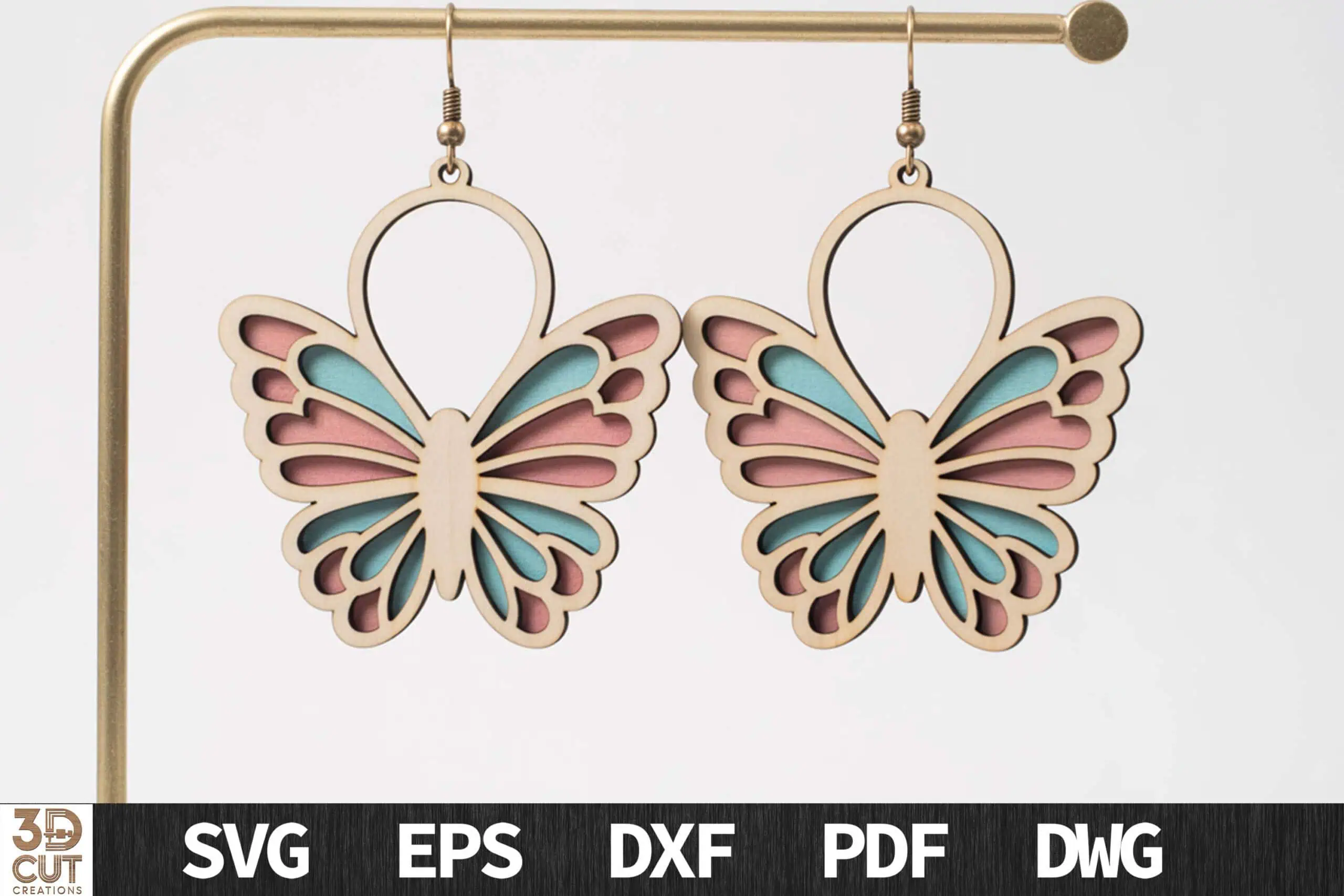 layered butterfly earrings in cream, pink and mint hanging from a gold earring stand