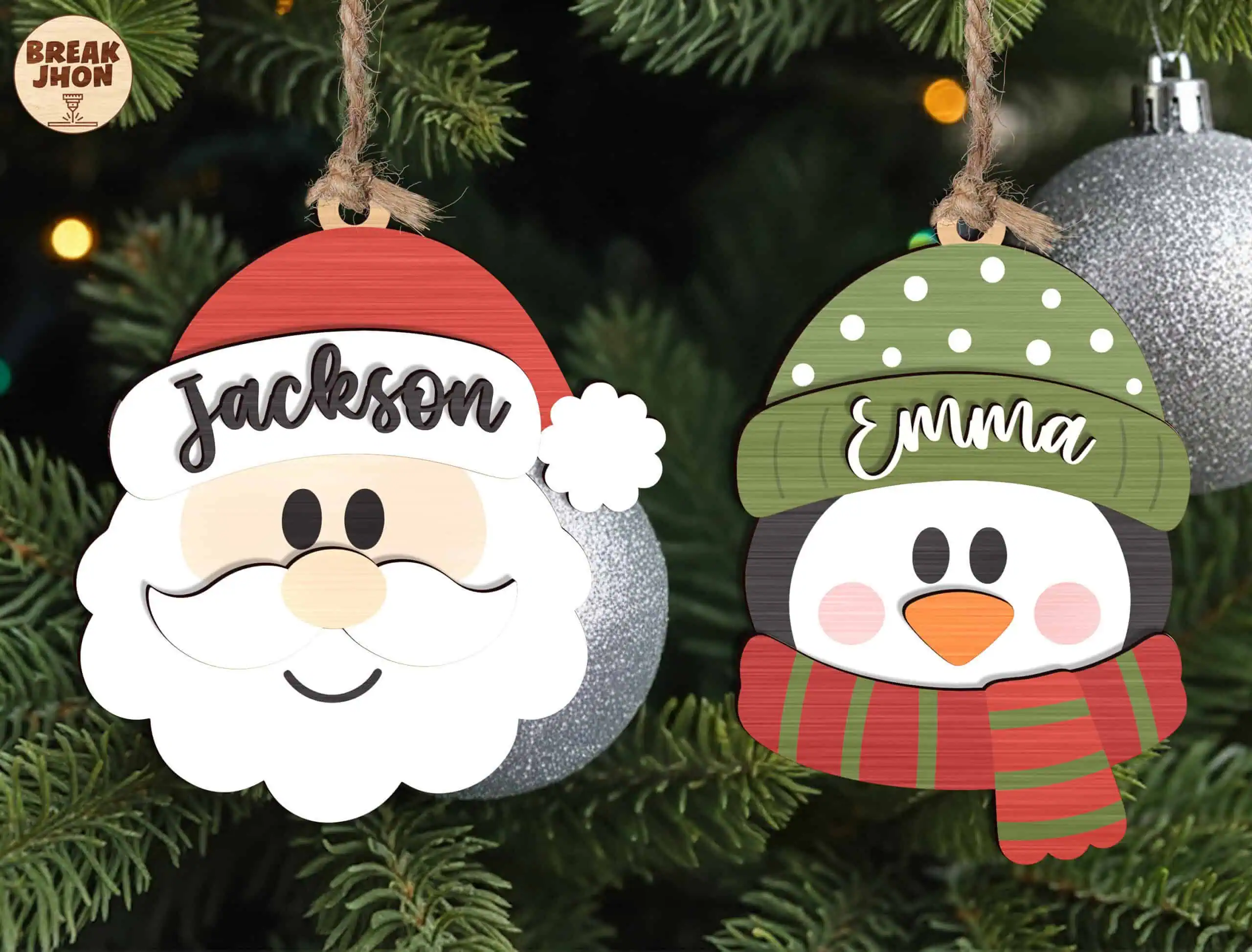 two personalized ornaments, a Santa face with the name Jackson and a penguin with the name Emma
