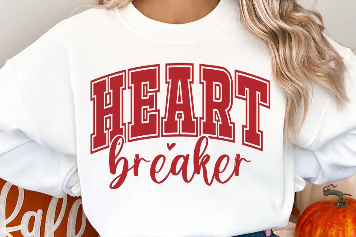 white sweatshirt that says HEART in red varsity letters with breaker in script