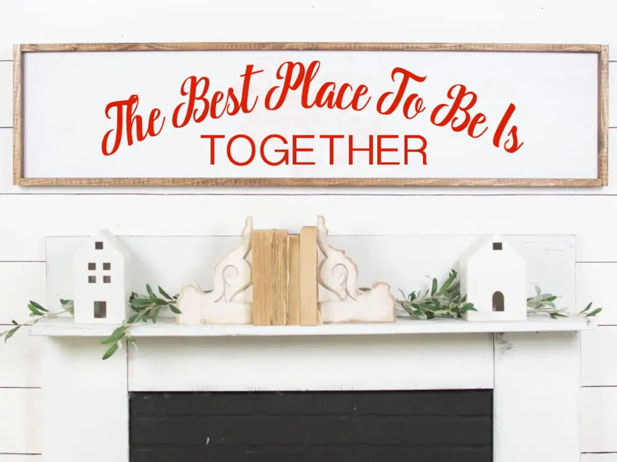 long white wood sign that says the best place to be is together in red script