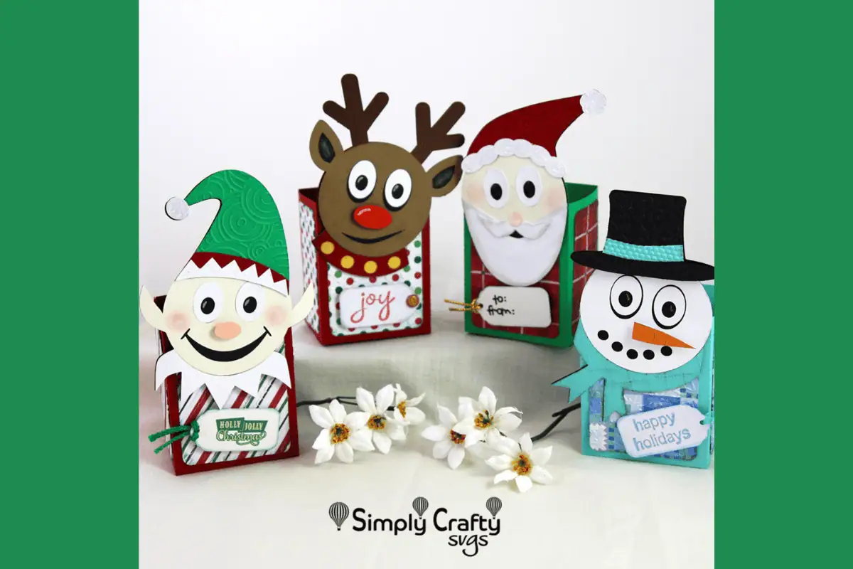 four paper treat boxes shaped like an elf, a reindeer, Santa and a snowman