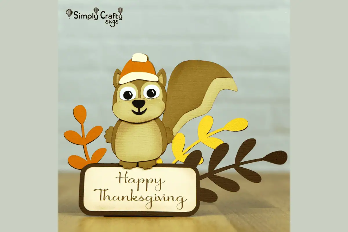 paper squirrel treat box holding a Happy Thanksgiving sign